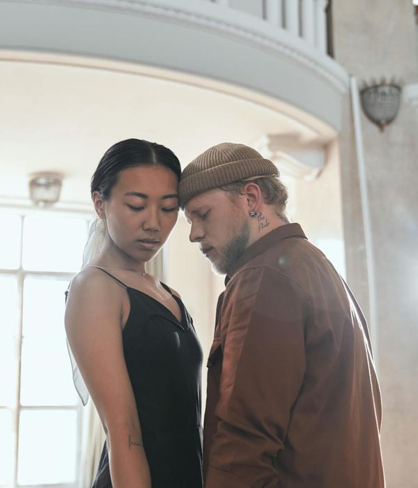 Man performing a kettlebell swing with focused expression.